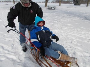This is me on the sled with Jason on the back with the brake.  It was really cool to get to ride in the sled while Sascha was helping the team to pull.