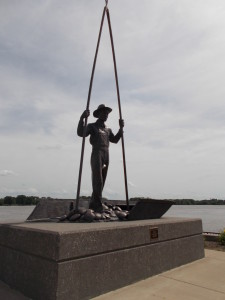 Statue of clammer commemorating the button industry in Muscatine.  Yep, that a container between his legs.