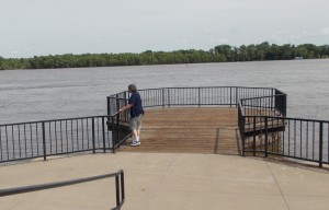 Rich standing on a landing by the Mississippi River.