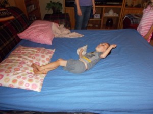 Cael enjoying a romp on the girls' bed.