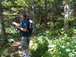 Rich is reading the description for an exhibit on the Spruce-Fir Nature Trail.