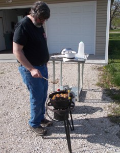 Rich pulling the golden hushpuppies out of the fryer.