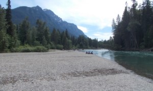 Everyone enjoying lunch beside McDonald River.