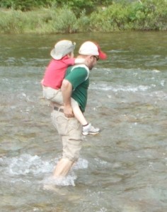 Zane gets a piggyback ride across the river.