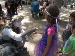 Bel getting her bracelet from the woodlawn fairy who does the spider web.
